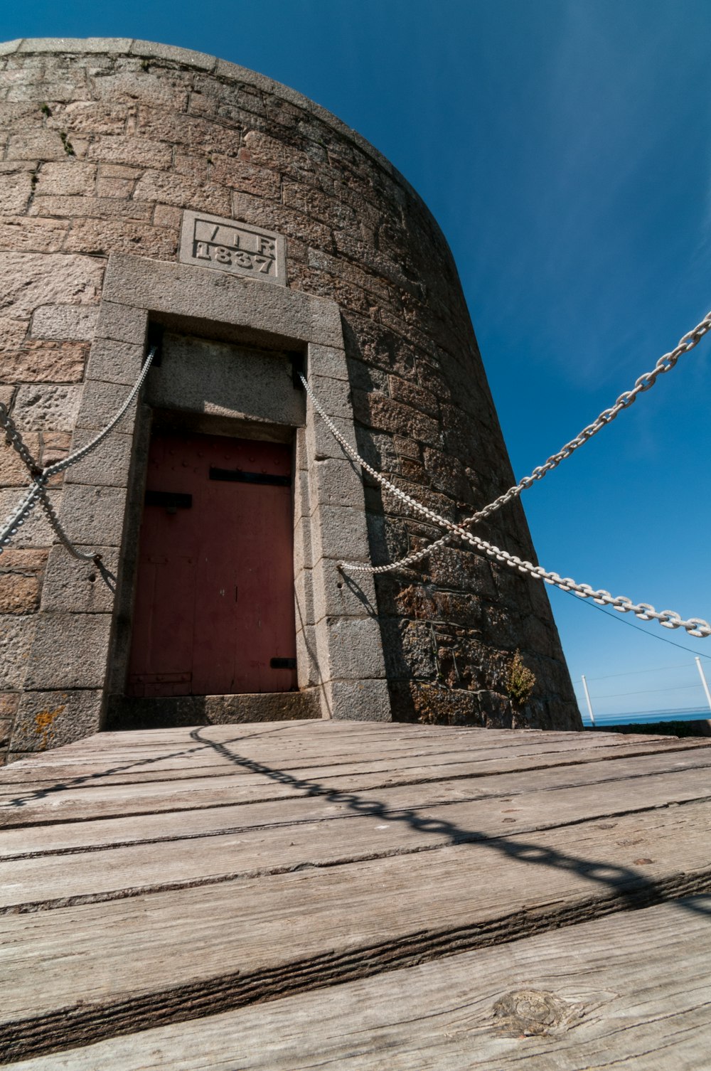 a red door is in a stone tower