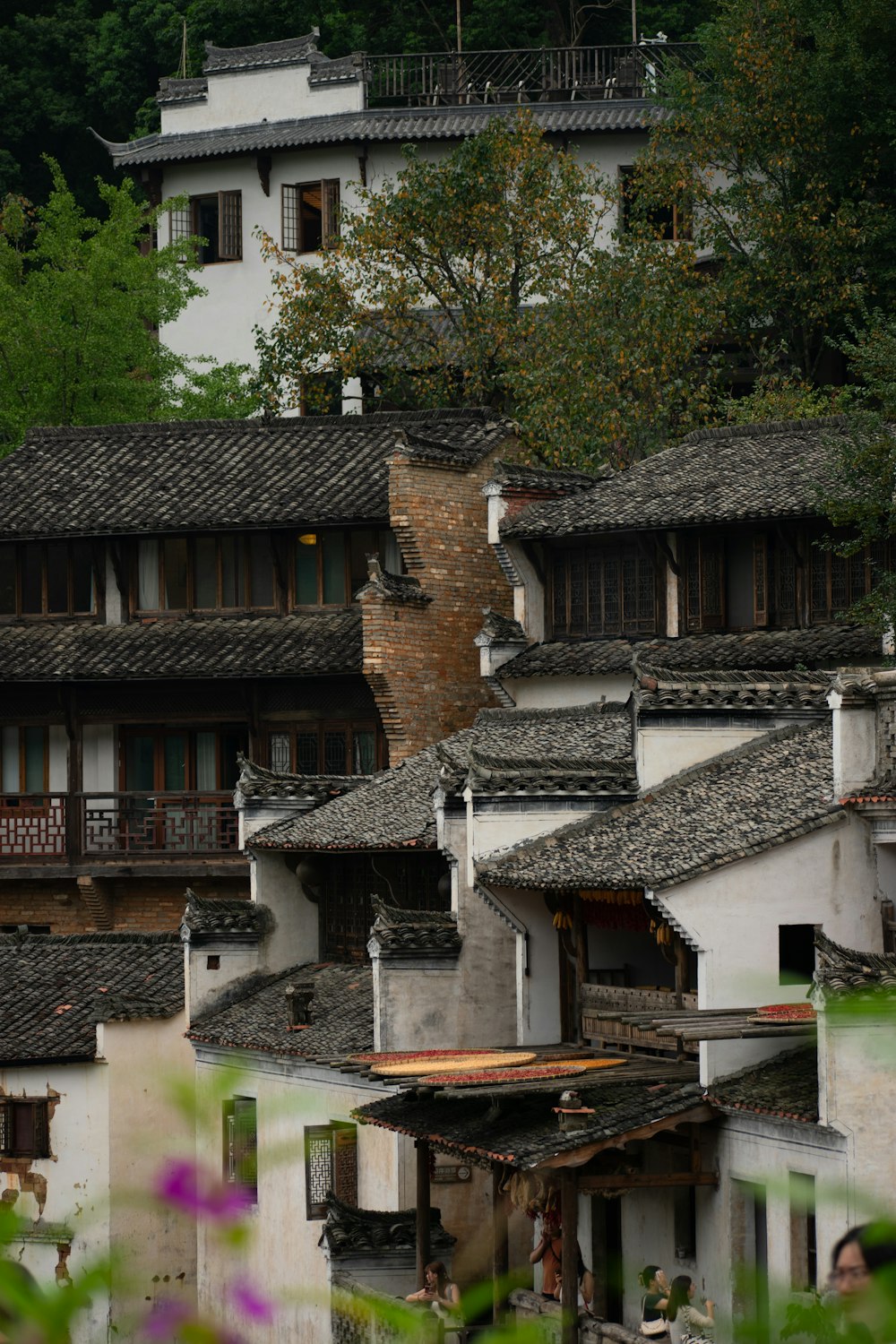 a row of buildings with a clock tower in the background