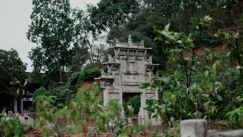 a stone structure sitting on top of a lush green hillside