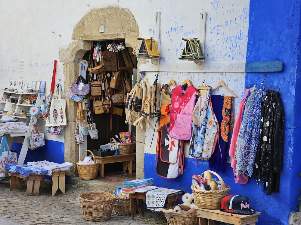 a blue and white building with a bunch of clothes on display