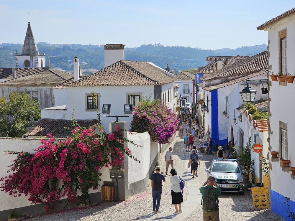 a group of people walking down a cobblestone street