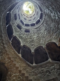 a round window in a stone building with a skylight