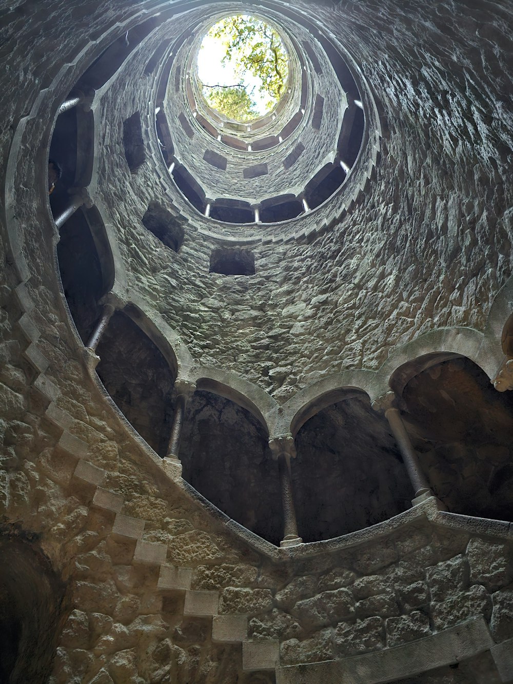 a round window in a stone building with a skylight