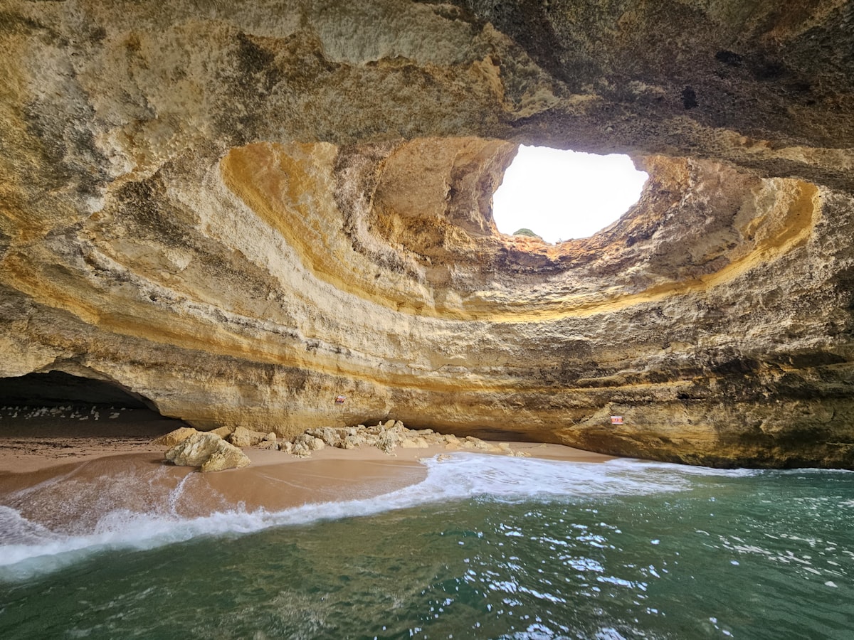 View from inside Benagil Cave looking out to the turquoise sea, Algarve Portugal