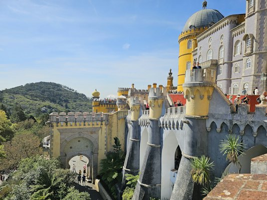 A castle like building with a yellow roof — Sintra, Portugal