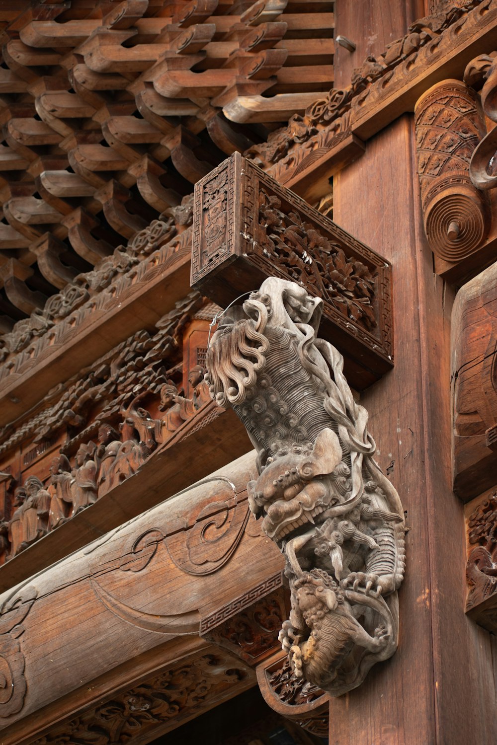 a wooden carving of a horse on the side of a building