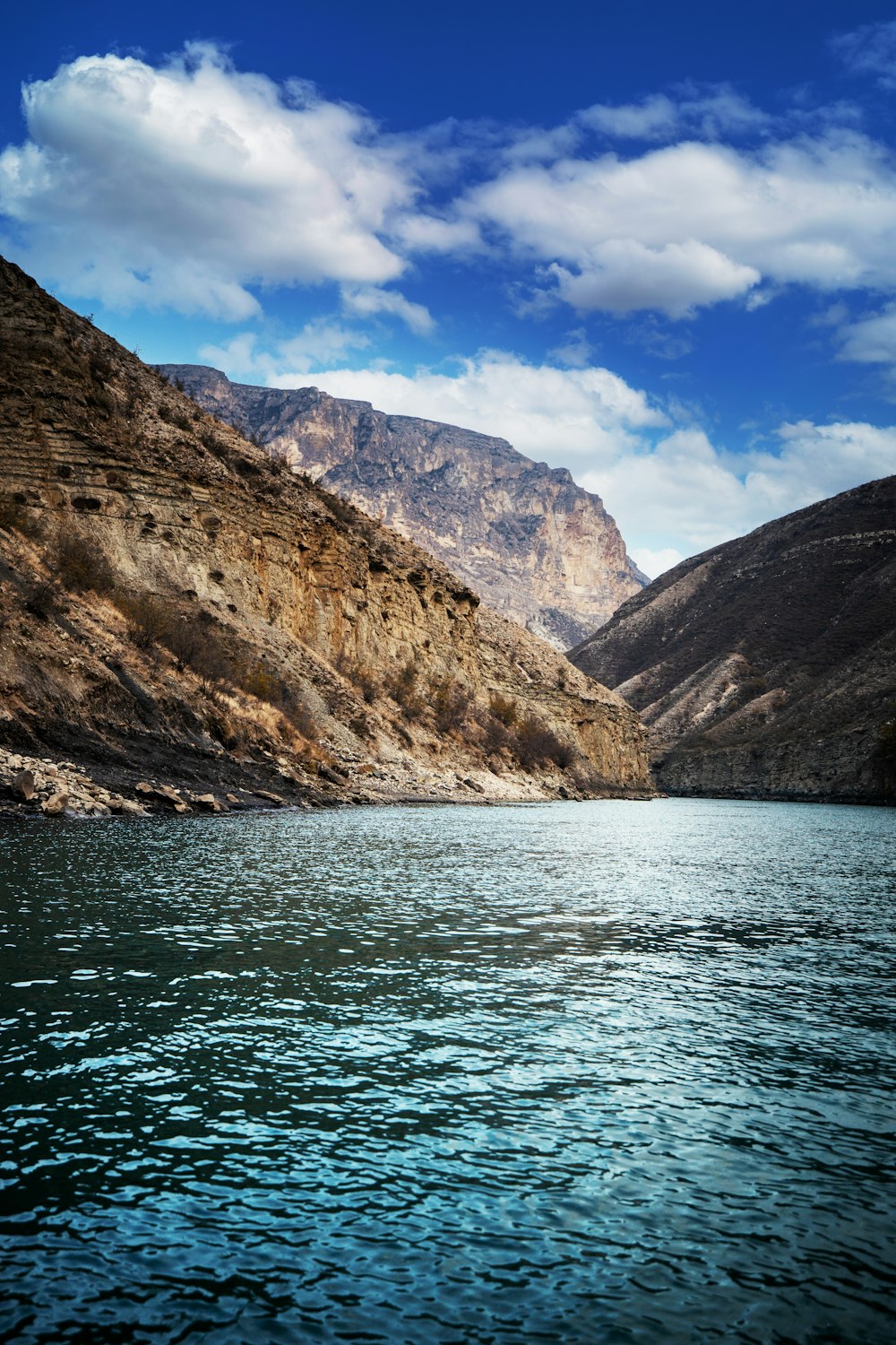 a body of water with mountains in the background