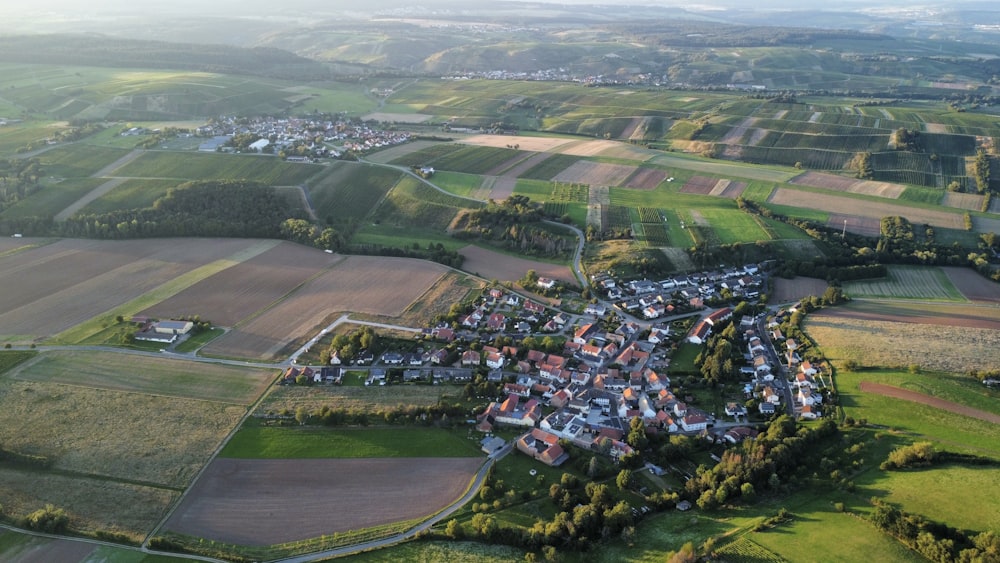 an aerial view of a small village surrounded by fields