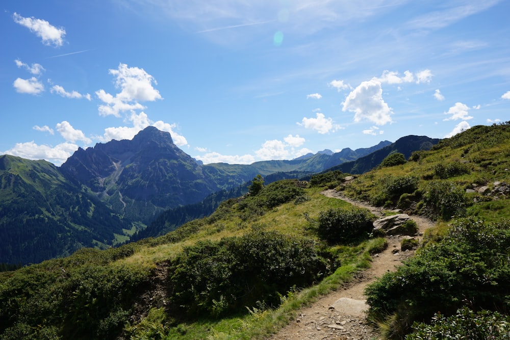 a dirt path in the middle of a mountain range