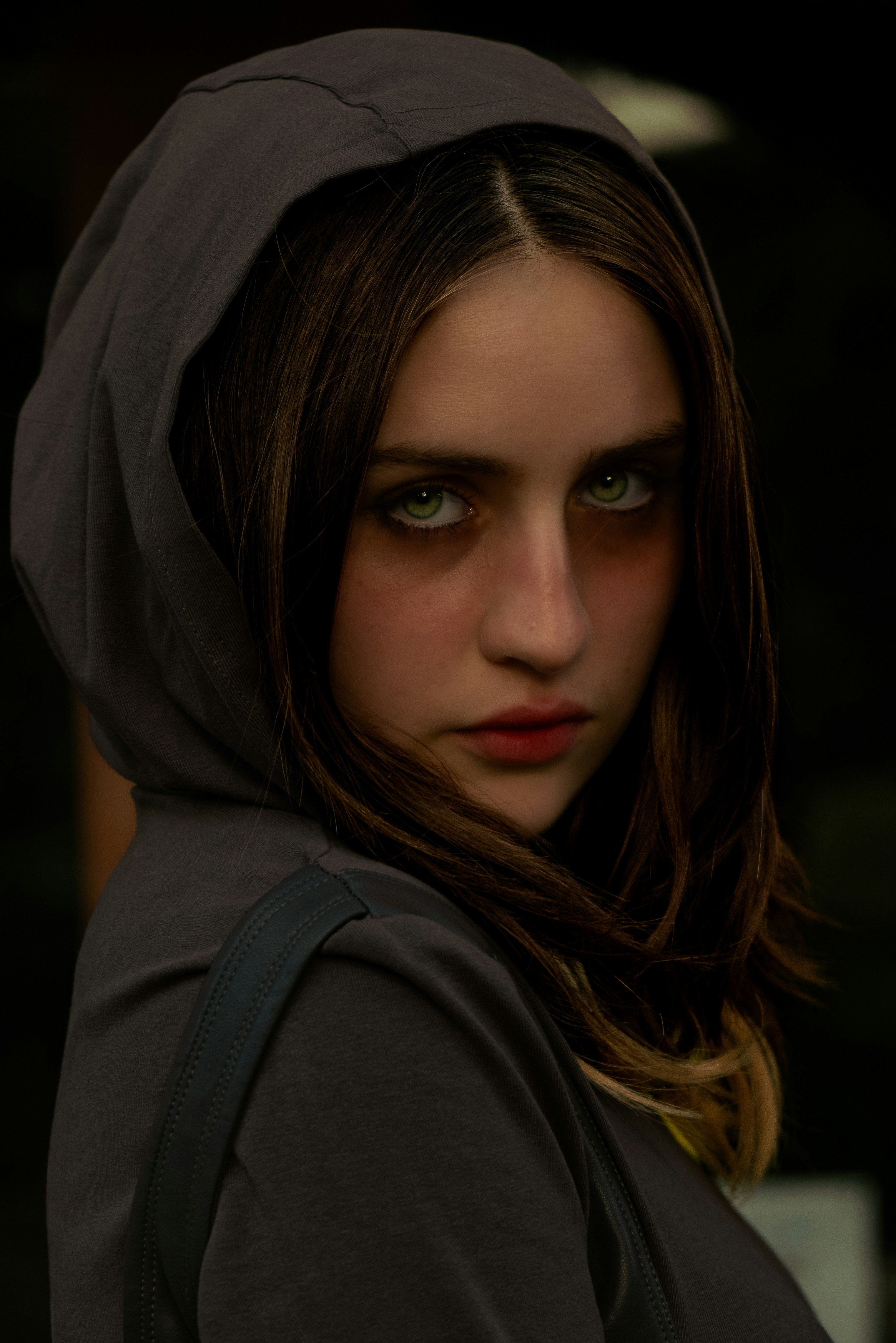 A woman with a hoodie on looking at the camera photo – Free Portrait ...