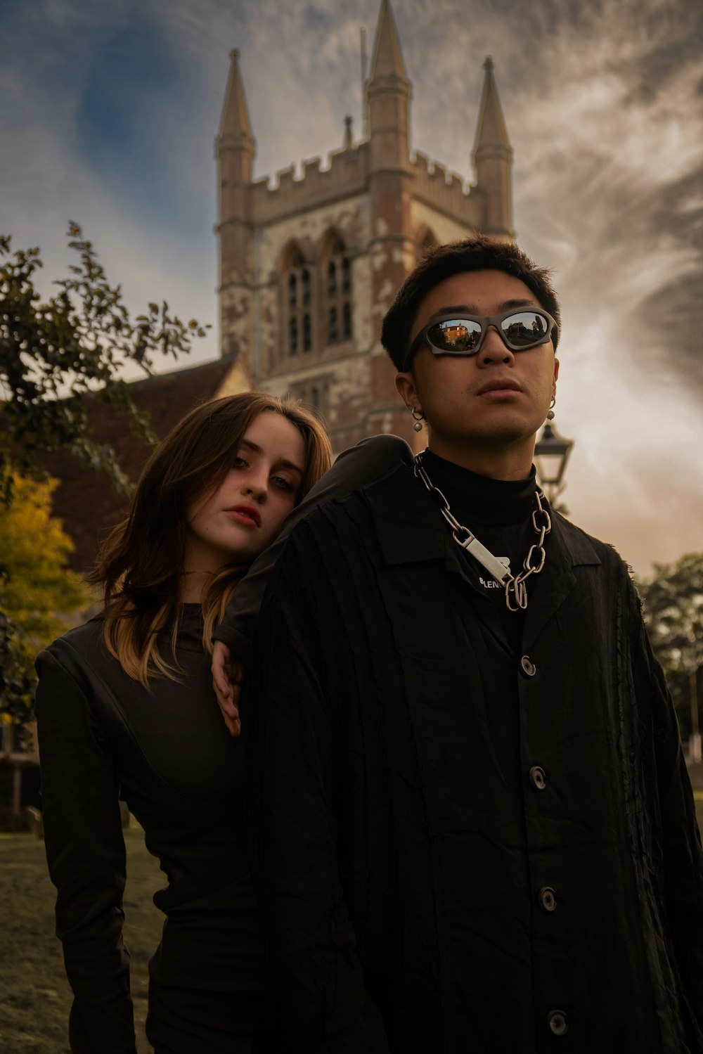 a man and a woman standing in front of a church