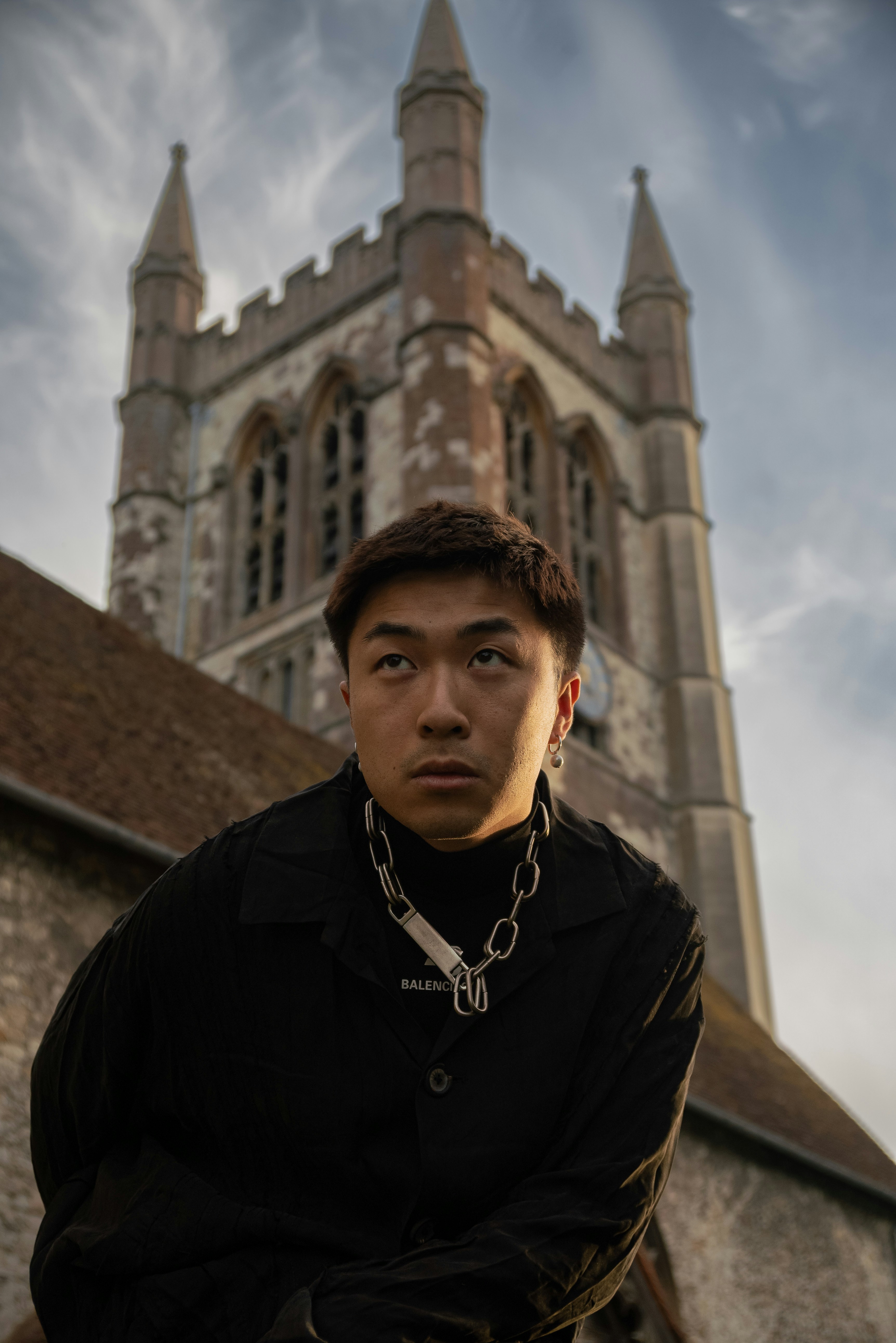 A man standing in front of a tall building photo – Free Portrait Image ...