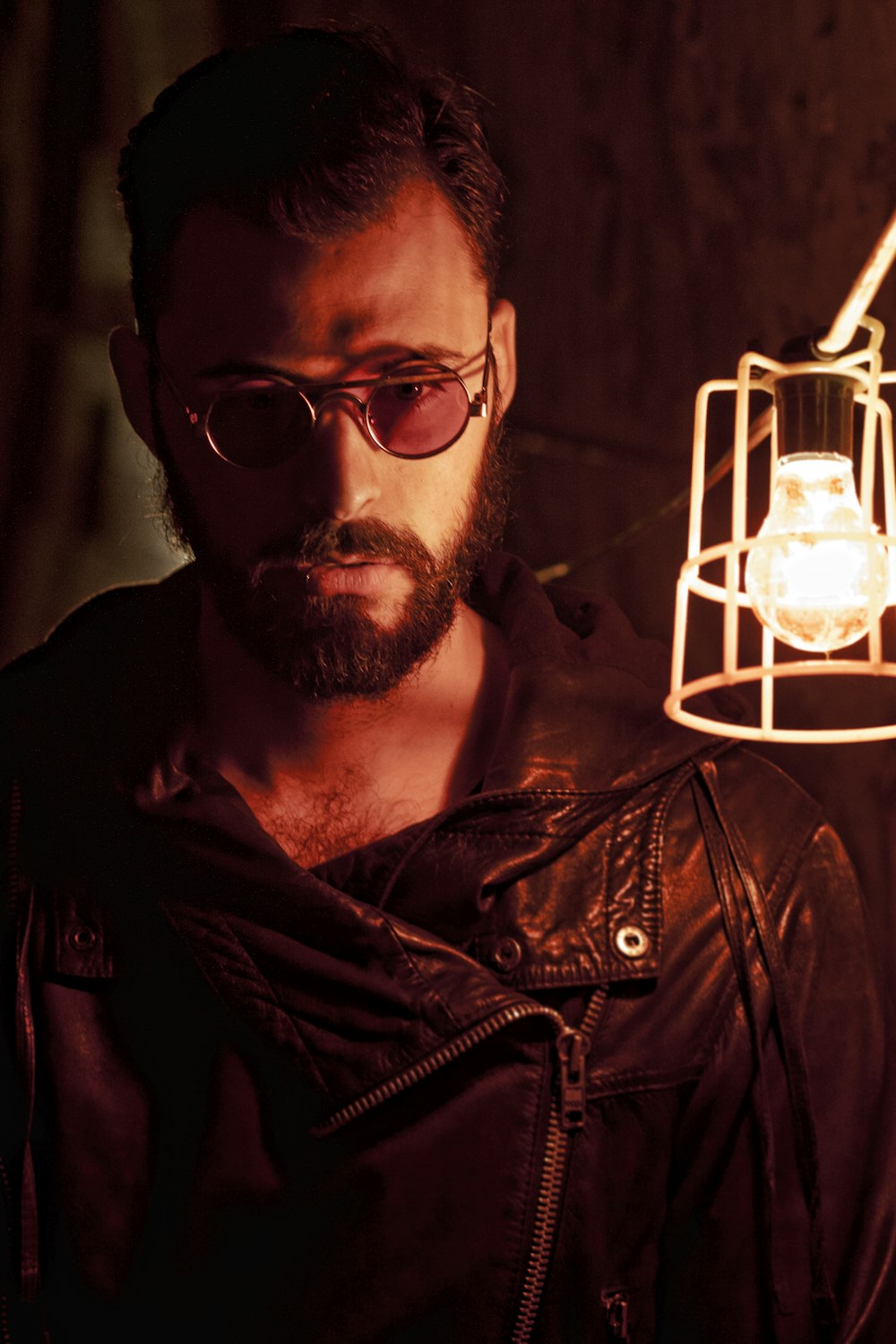 a man in a leather jacket holding a light