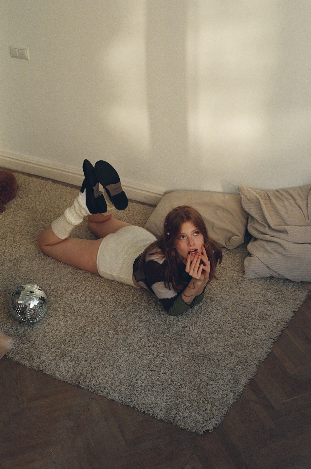 a woman laying on the floor with a stuffed animal
