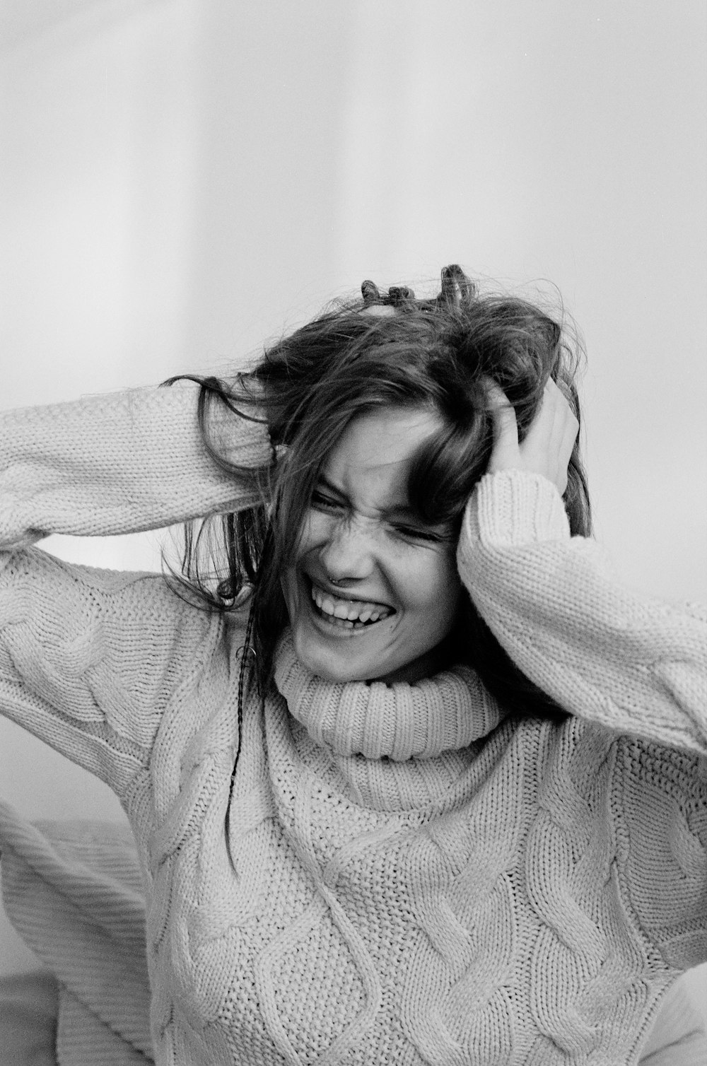 a black and white photo of a woman smiling