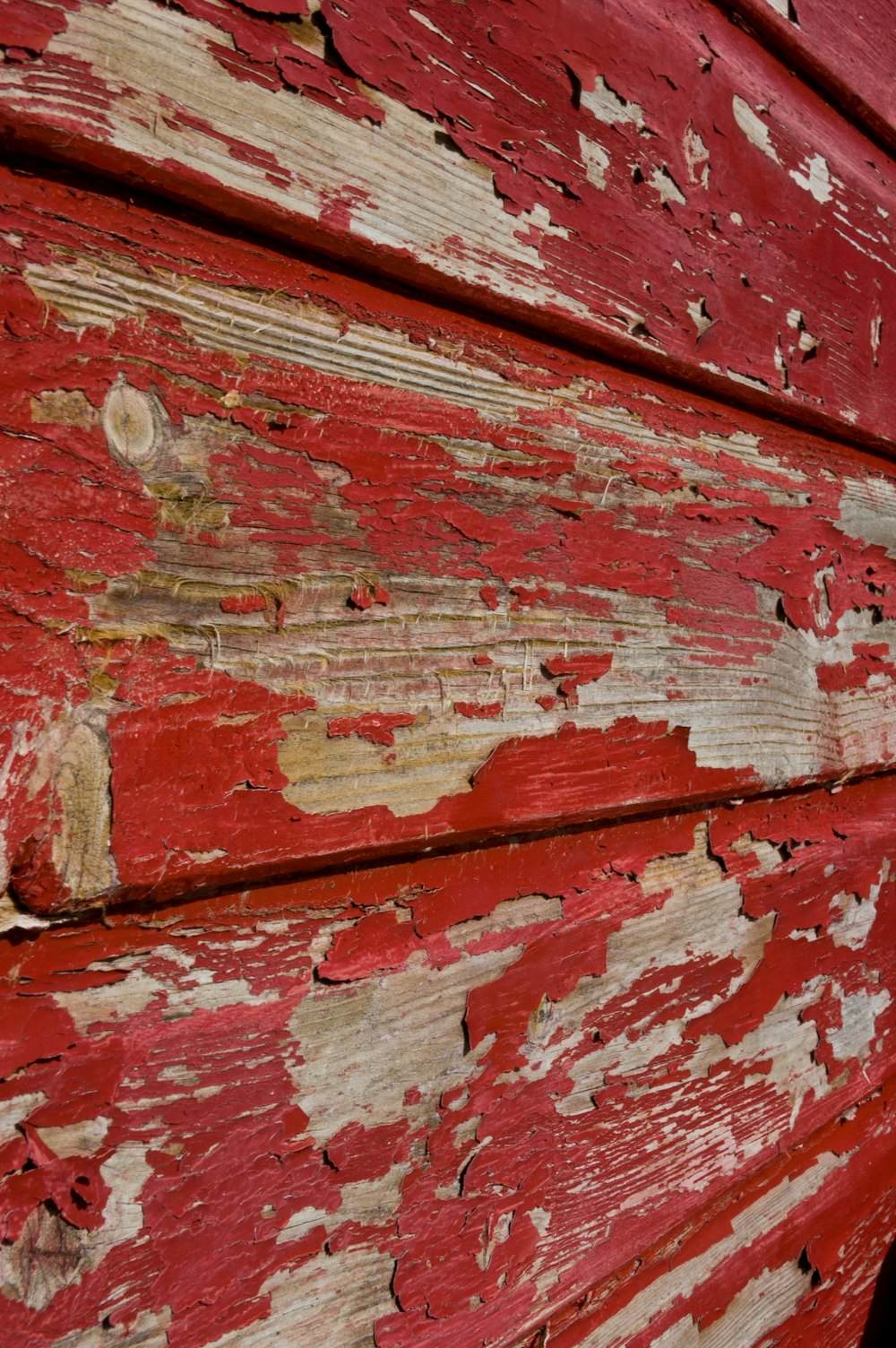 a close up of a red and white wooden structure