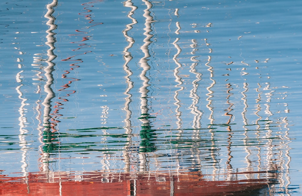 the reflection of a boat in the water