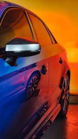 A car wrapped in reflective material showcasing neon colors.