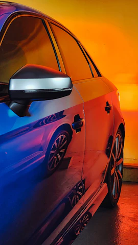 Side view of a vibrant vehicle wrapped in a bold, custom color design.