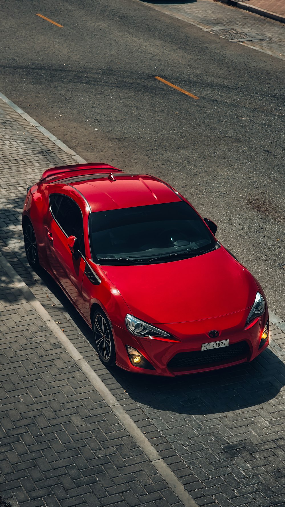 a red sports car parked on the side of the road