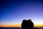 A peaceful observatory dome silhouetted against a colorful twilight sky.