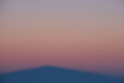 Abstract violet-pink gradient overlay on a blurred office scene symbolizing ai governance.