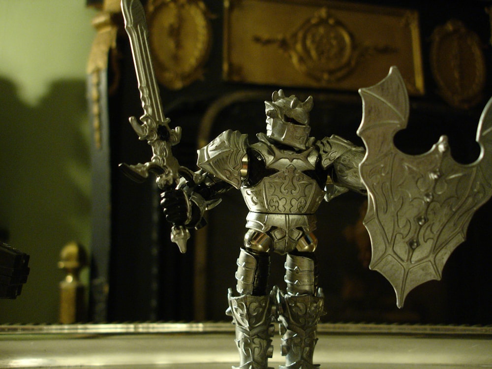 a toy figurine of a knight holding a sword