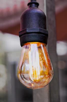 Retro Edison bulb lamp with warm filament light in a vintage setting.
