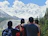 Happy group of friends enjoying a scenic mountain view during a luxury trip.