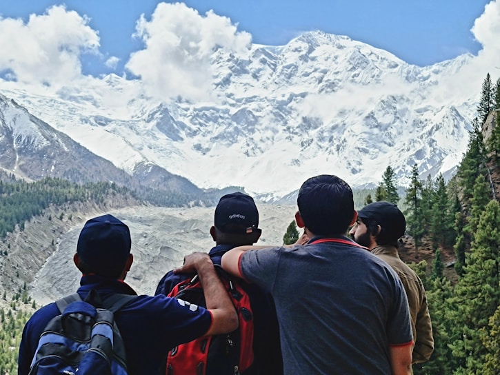 A vibrant group of travelers enjoying a scenic mountain view in Peru.