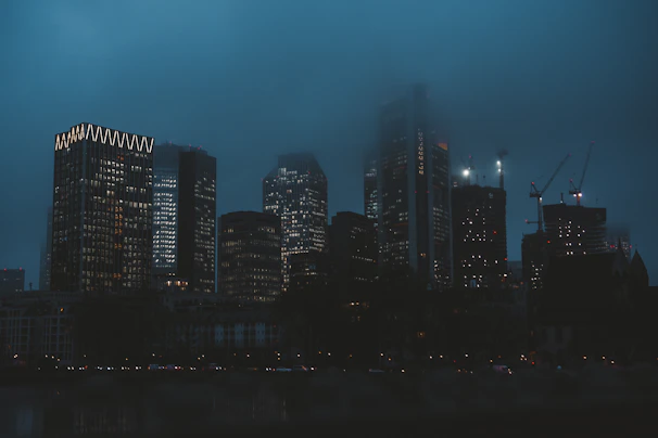 A sleek city skyline at dusk with illuminated office towers symbolizing stability and growth.