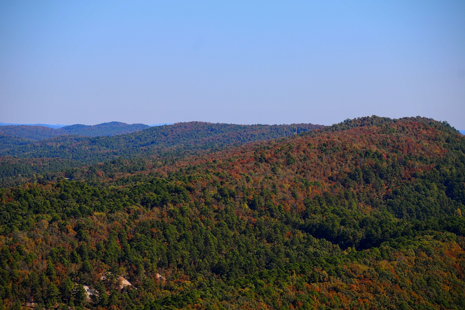 a view of a mountain range with trees in the foreground