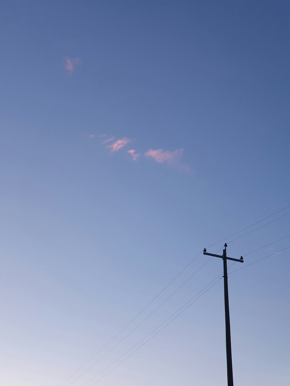 a telephone pole with a sky in the background