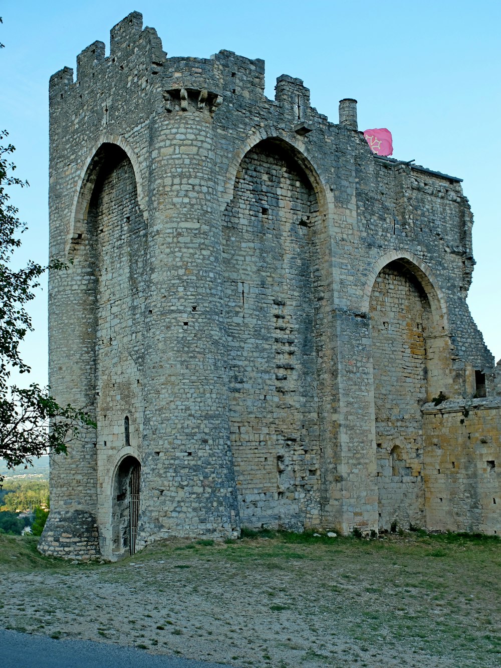 a large stone castle with a red flag on top of it