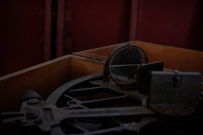 Close-up of an antique sextant against a backdrop of aged parchment.