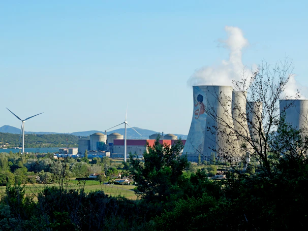 A panoramic view of a clean energy power plant integrated into a lush green landscape.