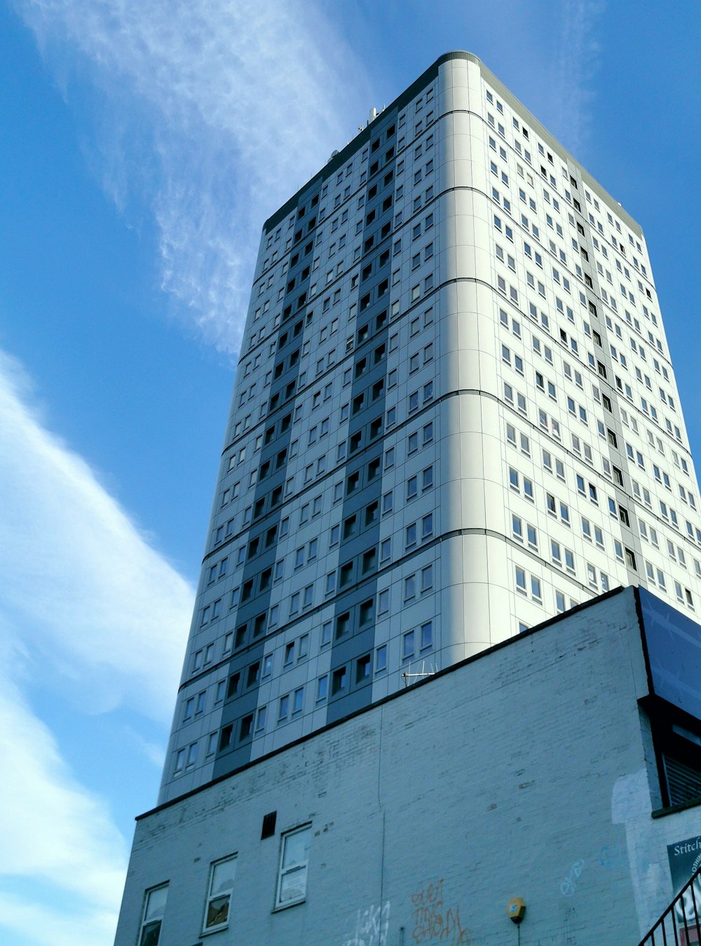 a tall white building with lots of windows
