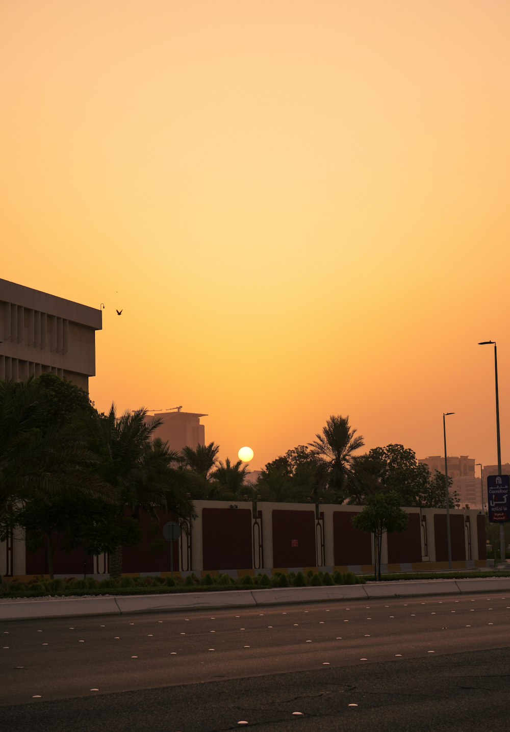 the sun is setting over a city street