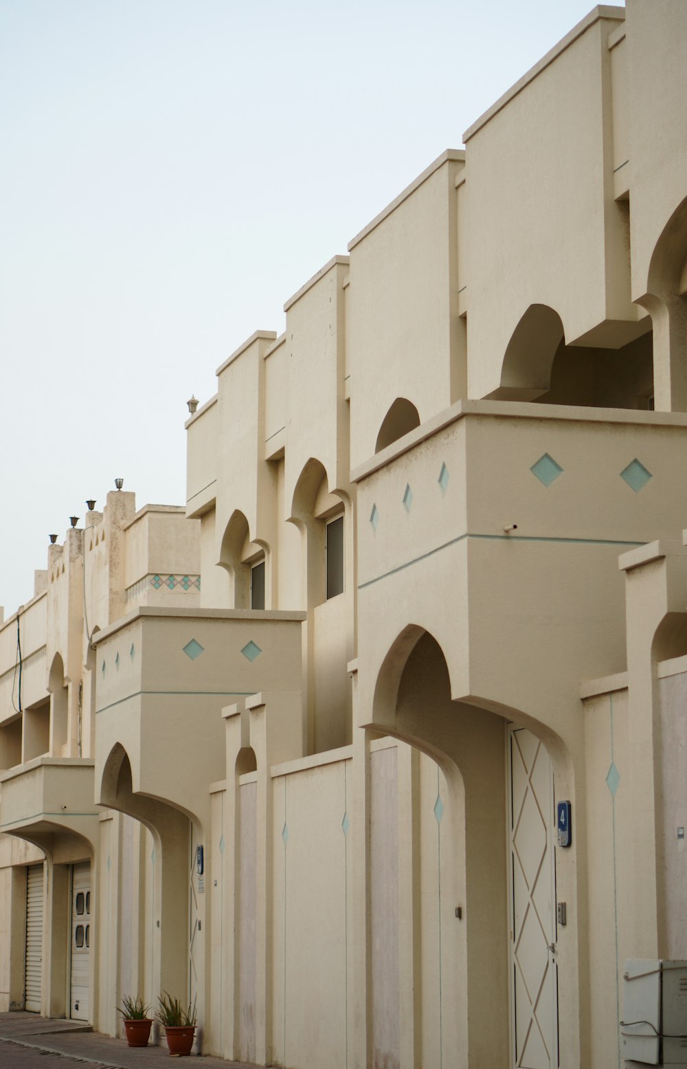 a row of beige buildings with a blue sky in the background