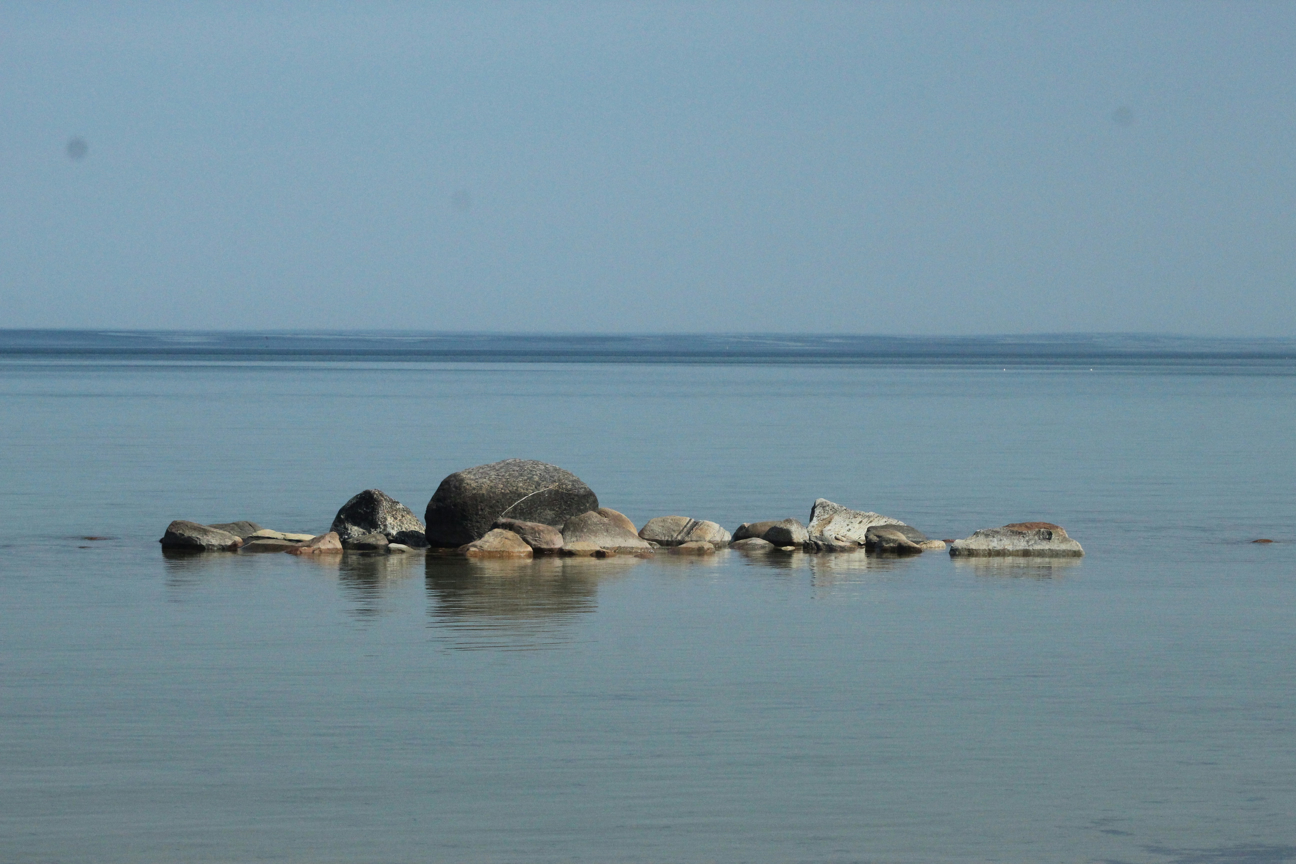 a group of rocks sitting in the middle of a body of water