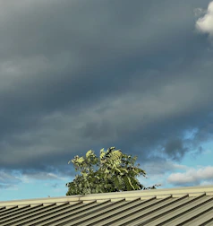 A roofing expert responding promptly to an emergency call during a stormy day.