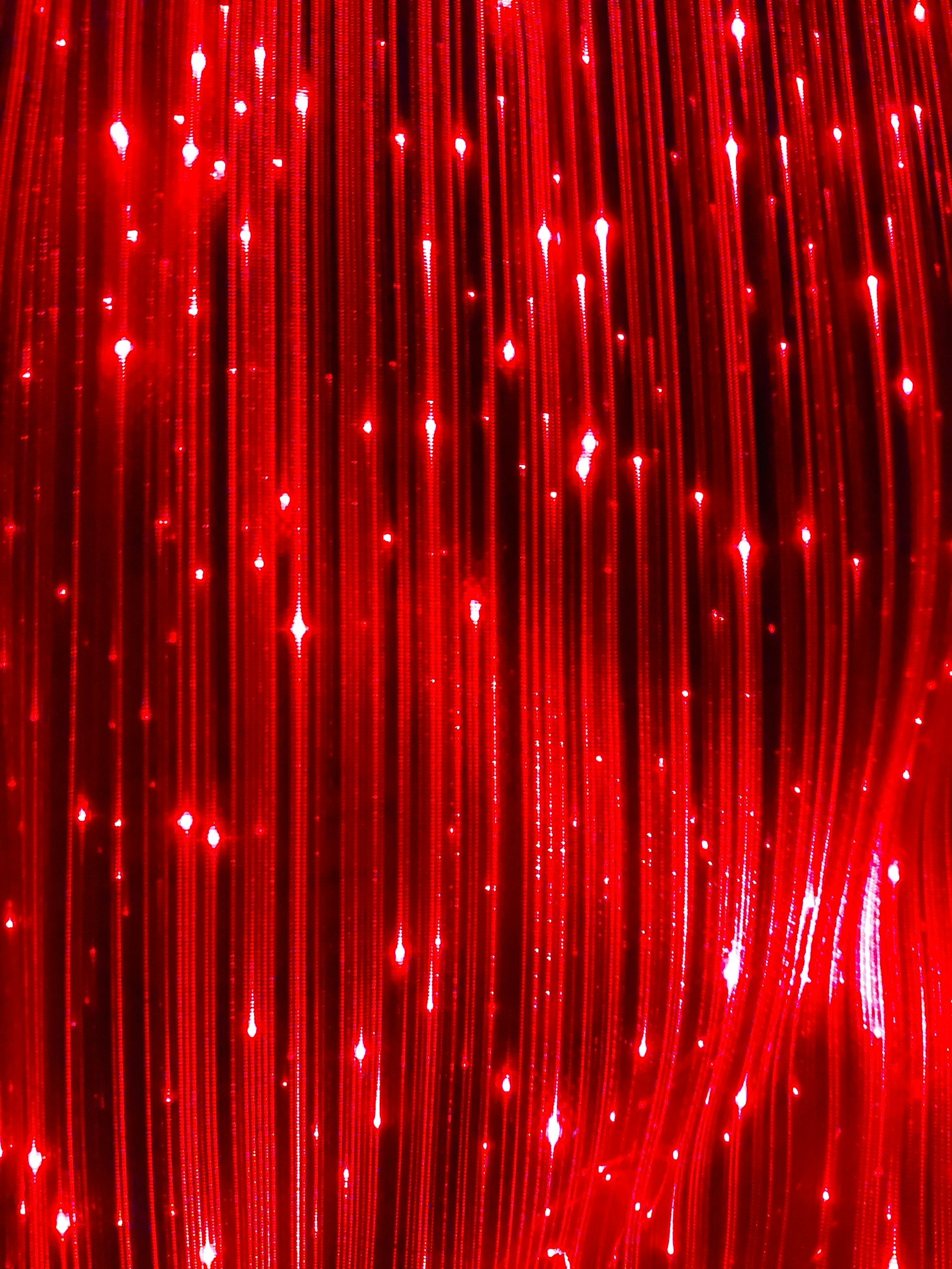a close up of a red string curtain