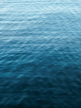 Calm blue waves gently flowing, reflecting peaceful wellness.