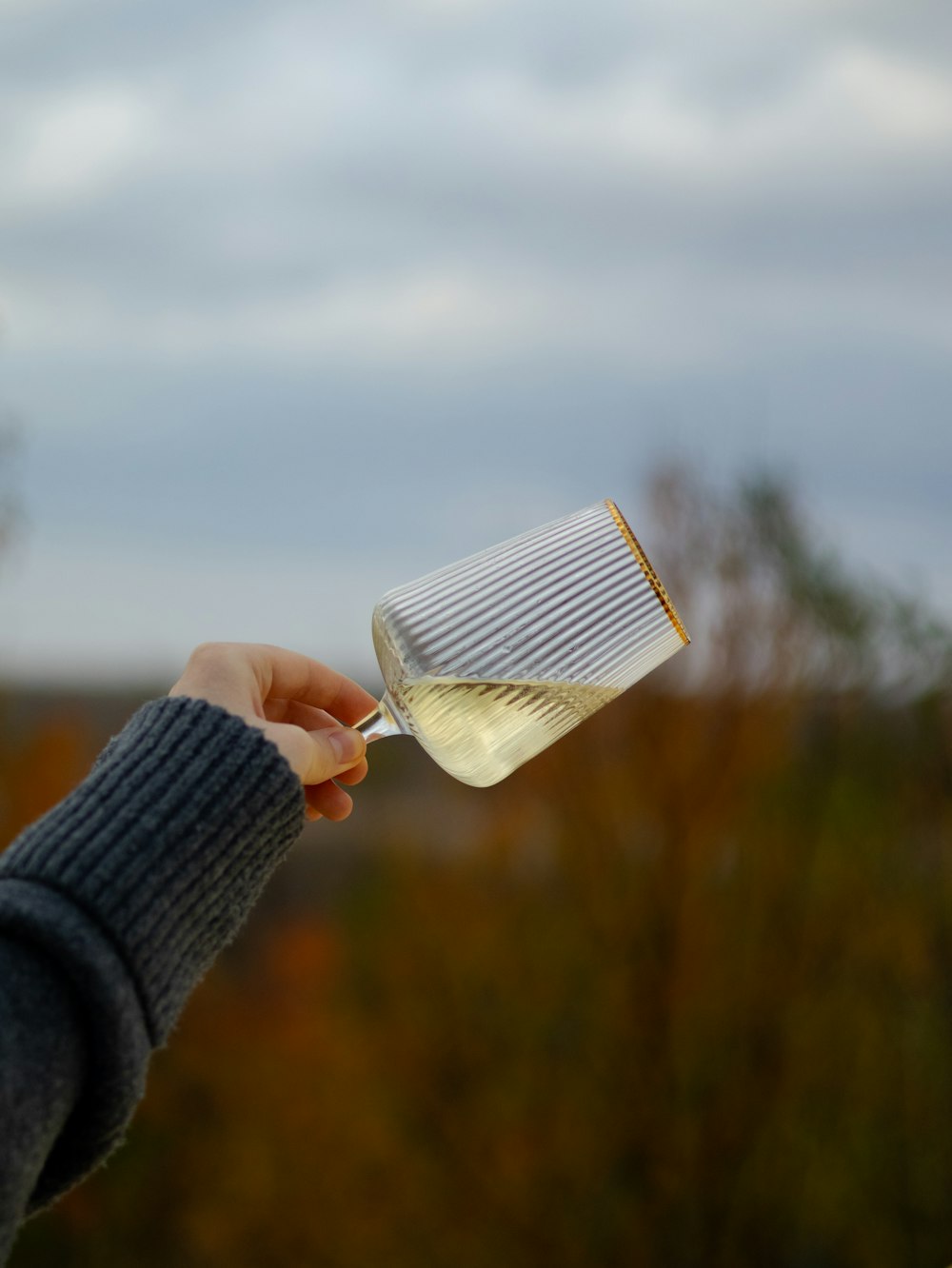 una persona sosteniendo un vaso con un líquido en él