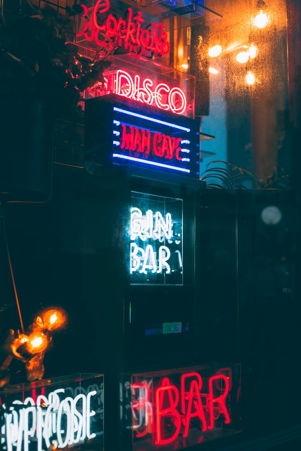 a bunch of neon signs on the side of a building