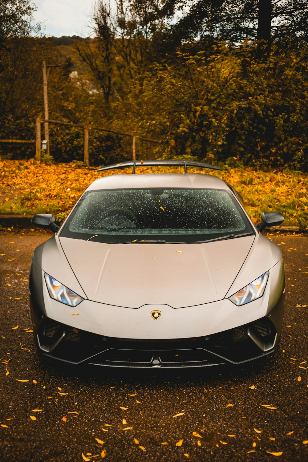 a white sports car parked in a parking lot