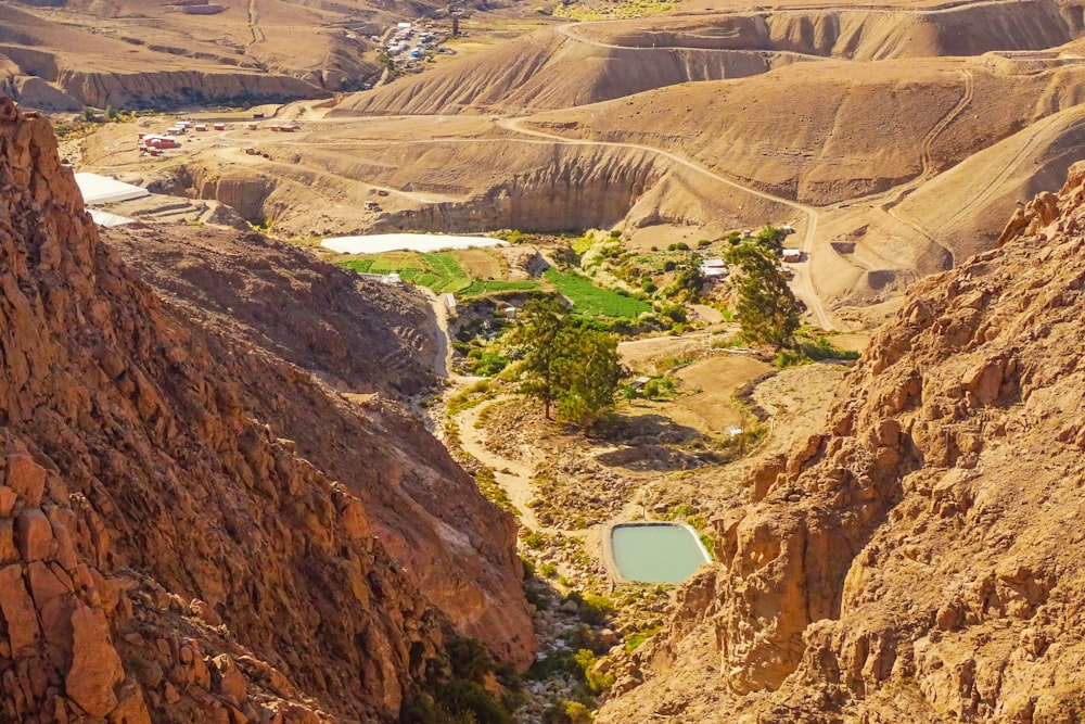 a view of a valley with a small lake in the middle of it