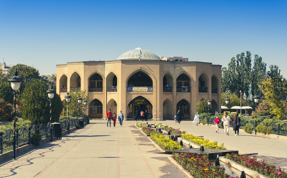 a group of people walking in front of a building