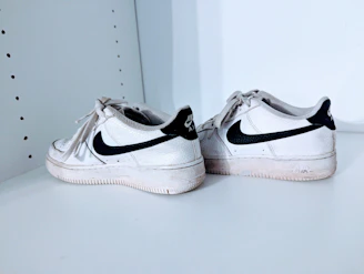 A sleek pair of classic second-hand running shoes with visible character and style.