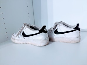 A stylish pair of Adidas running shoes with visible signs of use but still vibrant colors.